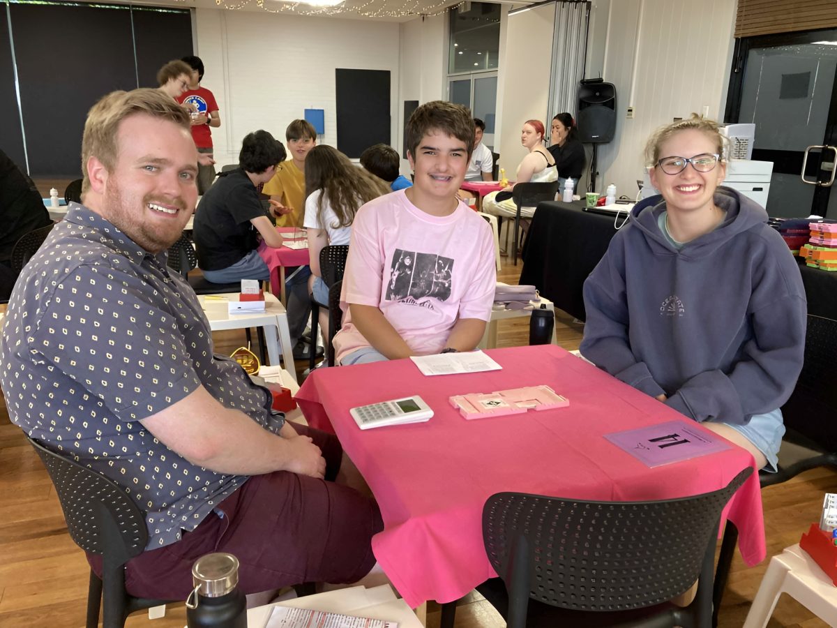 Three people playing cards